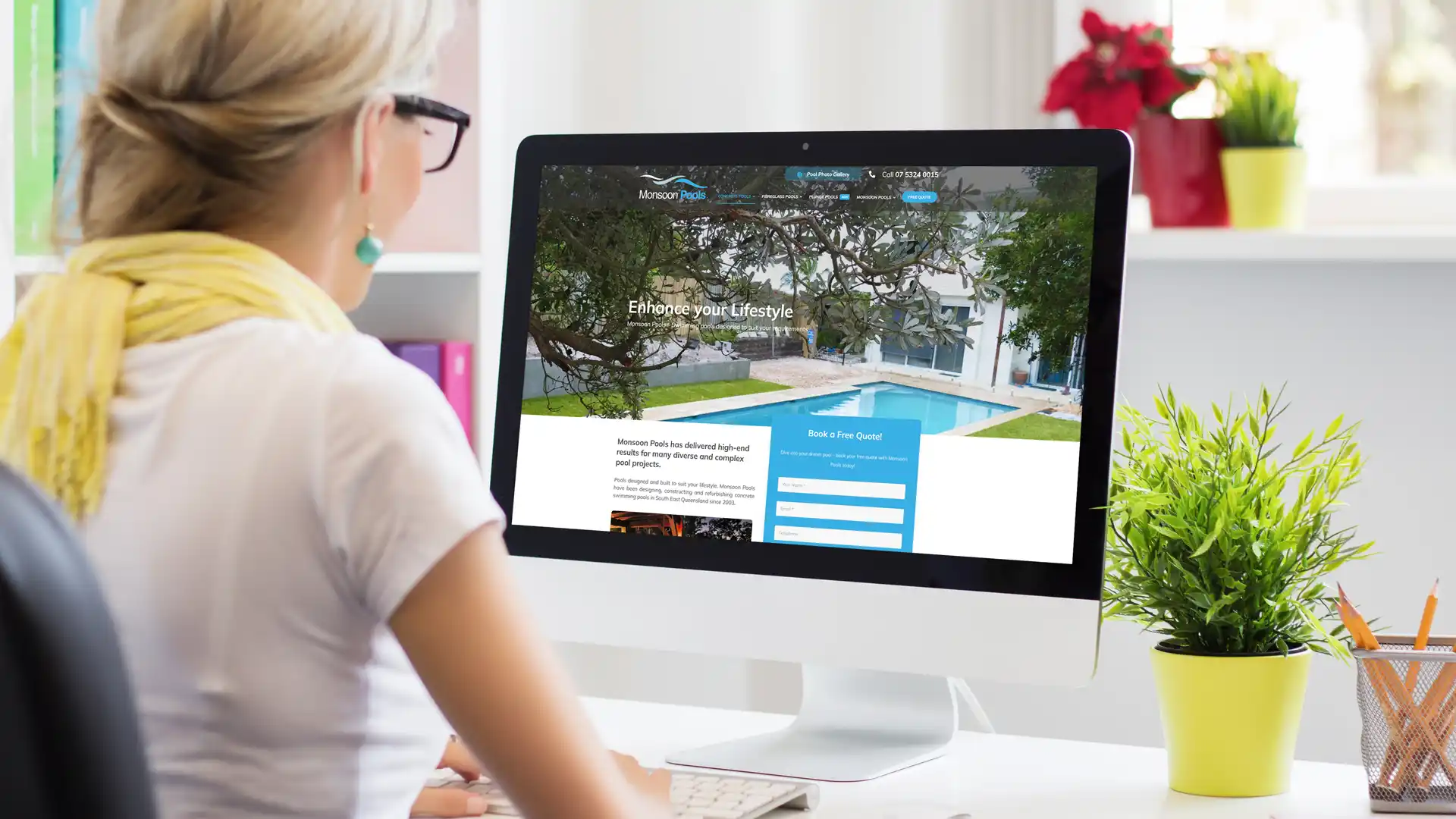 Designer viewing a website layout on screen, showcasing professional web design and branding for Sunshine Coast businesses.
