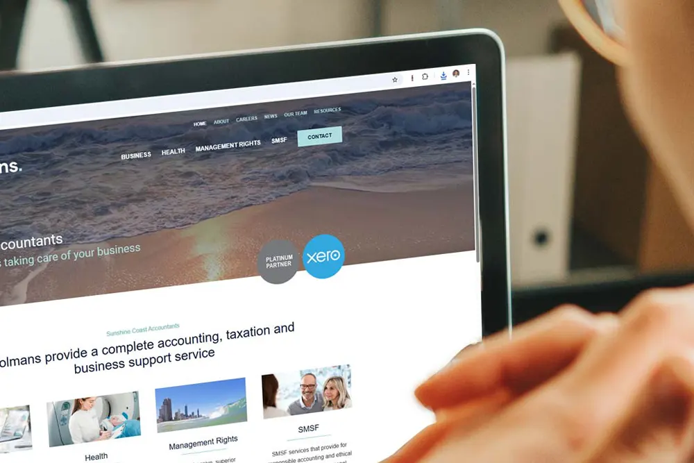 Person viewing a Sunshine Coast business website on a laptop screen, representing professional web design.